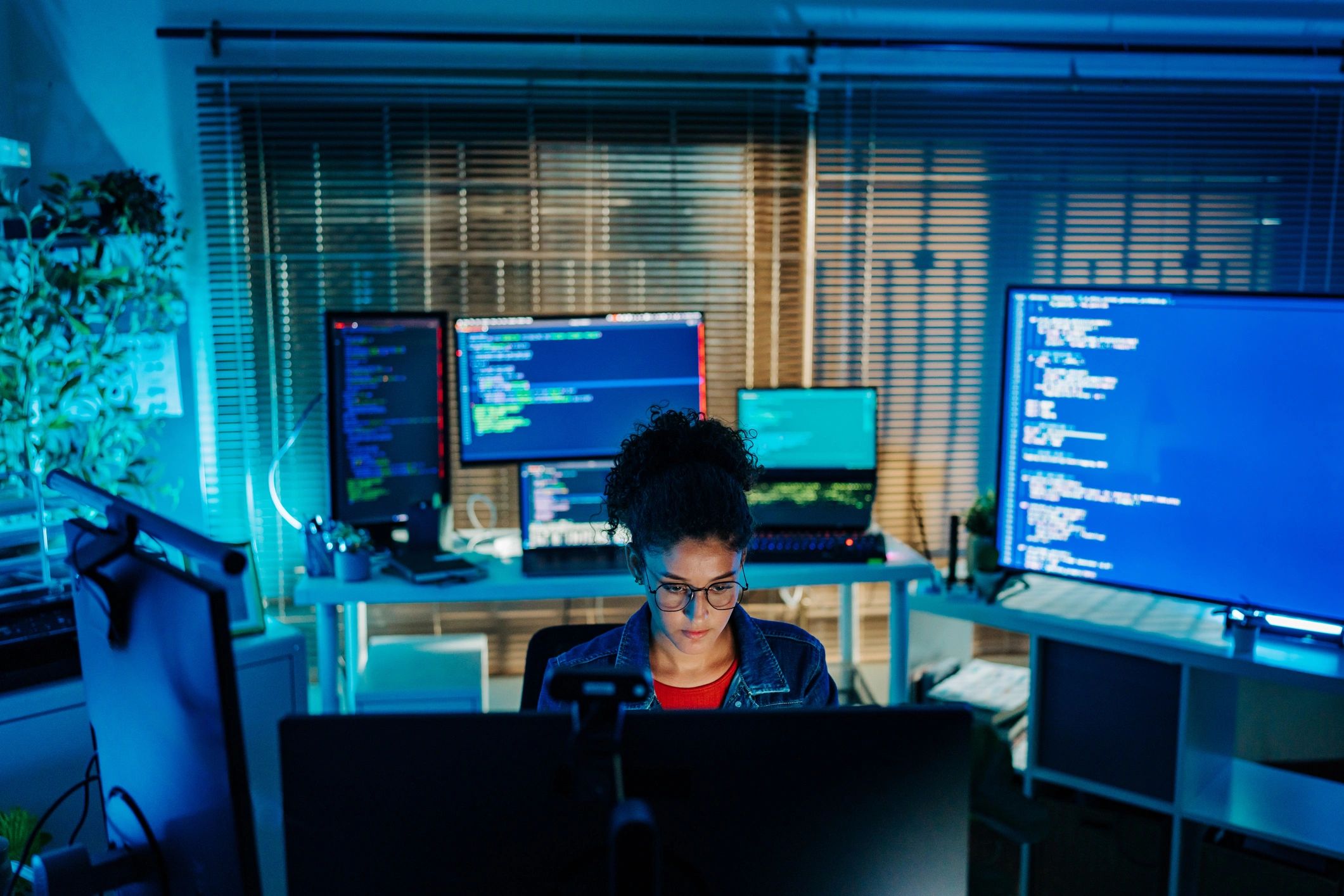 Engineer working at a multi-monitor workstation for digital part design